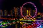 Colorful large ferris wheel over Yongle Bridge, Tianjin, China. Built in 2007. Art Print
